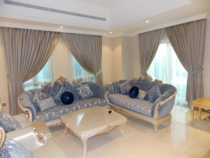 American Curtains with Sheers & Sofas of Living Area    